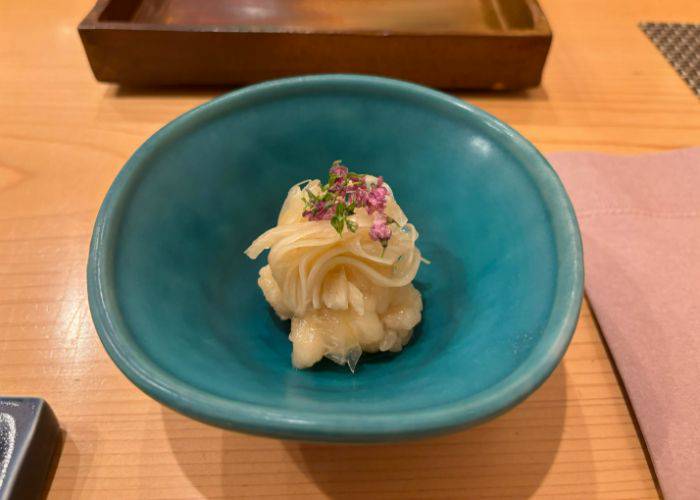 A unique appetizer of sour onion and fish at Sushi Tenkawa.